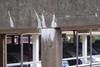 A concrete stalactite formed on the concrete outside a car park