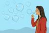 A woman blowing bubbles in the shape of speech bubbles