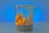 A photo of flames in a glass beaker