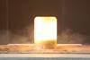 A small flash of heat, light and smoke contained within a large glass beaker