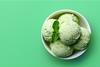 A bowl of mint ice cream on a green background