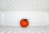 A tomato in a fridge