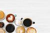 Assorted coffee cups on a textured background