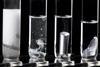 Four test tubes in a row with metals reacting in a clear liquid increasing in bubbles from left to right