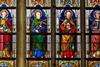 Stained Glass window depicting Catholic saints in the Cathedral of Saint Bavo in Ghent, Flanders, Belgium, including Jesus, Saint Paul and Saint Joseph