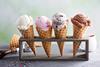 4 cones of ice cream in a stand