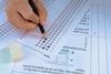 A student answering a multiple choice chemistry questions with a pencil