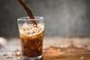Pouring a fizzing and bubbling glass of cola
