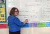 A teacher in front of a white board