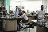 High school students studying in chemistry laboratory experiment class