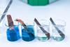 Electroplating experiment with pieces of metal in 4 separate beakers
