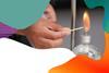 A hand is lighting a spirit burner with a match and there is a colourful border around the edge of the image