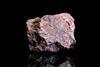 A photograph of a piece of red hematite iron ore against a black background