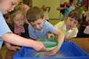 Young primary pupils sieving sand