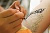 An artist applies a tattoo to skin