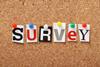 Different style letters spelling out SURVEY pinned to a notice board