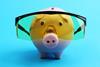A piggy bank wearing protective goggles