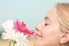 female smelling flowers
