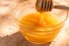 picture of honey in a bowl with a wooden dipper