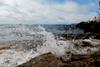 Seawater splashing against a rocky shore