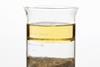 Photo of oil, water and sand separated in a beaker