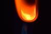 A photograph of a glass tube containing magnesium and copper oxide; the tube has been heated and glows as a reaction takes place.