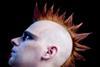 A man with a red and orange mohawk