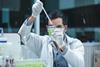 Scientist man is seriously doing formulation chemistry research