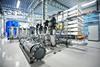 Inside a reverse osmosis plant with a collection of pipes and machinery.