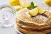 Stack of pancakes with lemon and sugar