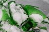 Pieces of a broken glass bottle with ice in a freezer, after the expanding water caused the bottle to explode