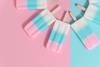Pastel striped lollies laid out in a circle on a flat pastel background