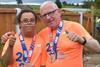 Stephen and his son, Michael, are giving the thumbs up at the camera. Both are wearing London Marathon finisher T-shirts and medals. 
