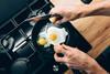 Someone frying eggs in a non-stick frying pan
