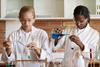 Two girls carrying out a chemistry experiment in a classroom