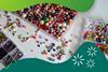 Colourful beads for jewellery making in trays some are sorted by type some mixed