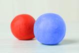 A red and a blue balls of plasticine