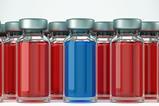 several ampules containing a red solution and one containing a blue solution