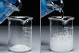 A series of photos showing a latex gloved hand pouring a colourless liquid onto a white powder, leading to a vigorous reaction of bubbles