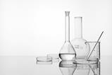 white background, glassware: flasks, beaker, stirring rod, petri dish