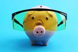 A piggy bank wearing protective goggles