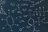 A picture showing a blackboard with chemical formulas written in white chalk
