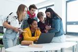 High school students gathered around a laptop