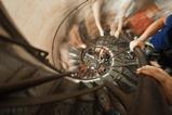 A photo looking down a spiral staircase with people climbing up