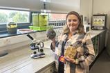 Lisa in a classroom lab with some geology samples