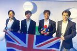 Four students with medals and a union jack flag