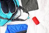 Sports clothes and a deodorant and bag laid out on a bed