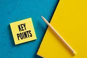 Post it with key points written on it next to a notepad and pencil