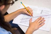 A photo of a school student drawing a graph