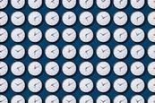 Rows and rows of identical clock faces showing different times